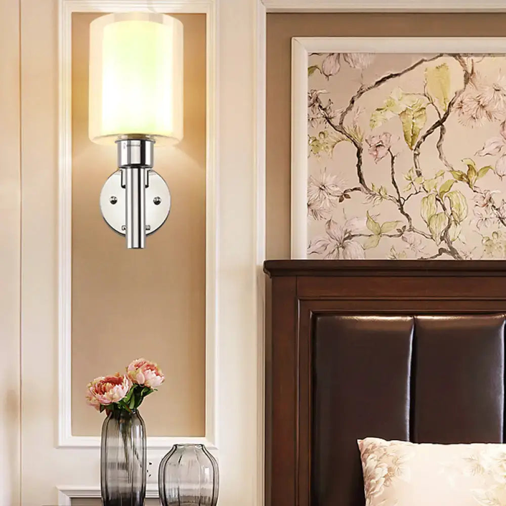 Chrome pencil-arm wall sconce with cylindrical white shade by Decorbites on Tampa Home & Garden Store