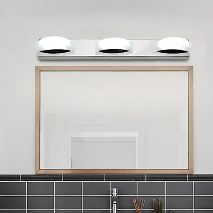 Chrome vanity mirror light with three round white glass shades on Tampa Home & Garden Store
