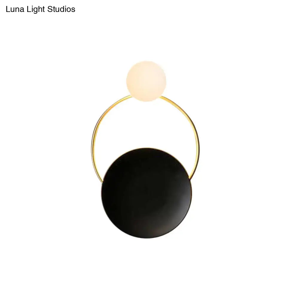 Black brass circle sconce with white frosted globe and gold ring by Decorbites on Tampa Home & Garden Store