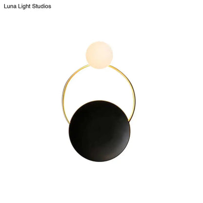 Black brass circle sconce with white frosted globe and gold ring by Decorbites on Tampa Home & Garden Store