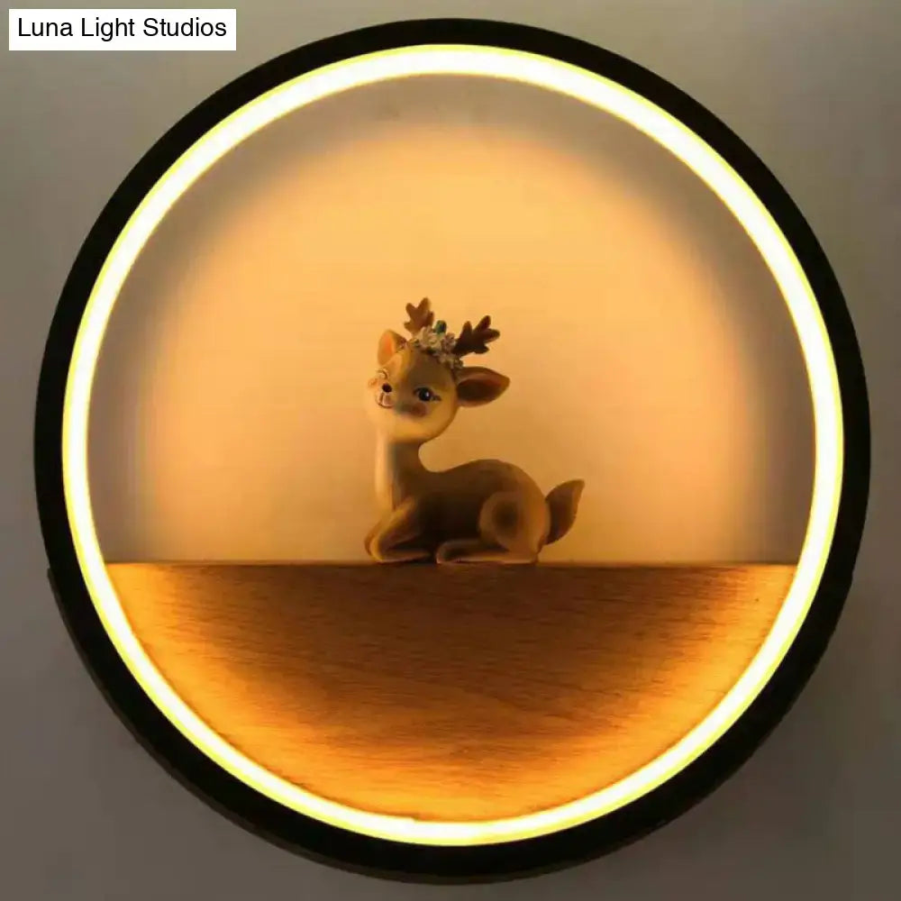 Black Deer Wall Light with circular LED halo and a cute deer figurine on a wooden shelf on Tampa Home & Garden Store