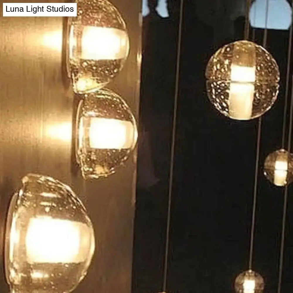 Bubble Crystal Wall Light with glass bubble pendants and warm white glow on a dark wall on Tampa Home & Garden Store