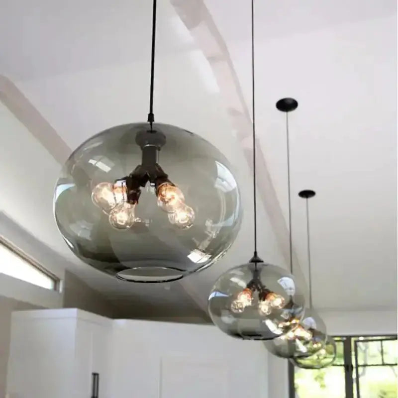 Decorbites smoky gray glass bowl pendant lights, trio with Edison bulbs over kitchen island on Tampa Home & Garden Store