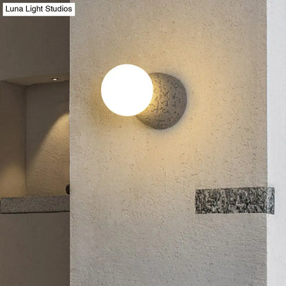 Pink Concrete Wall Sconce with round white globe, textured cement mount by Decorbites on Tampa Home & Garden Store