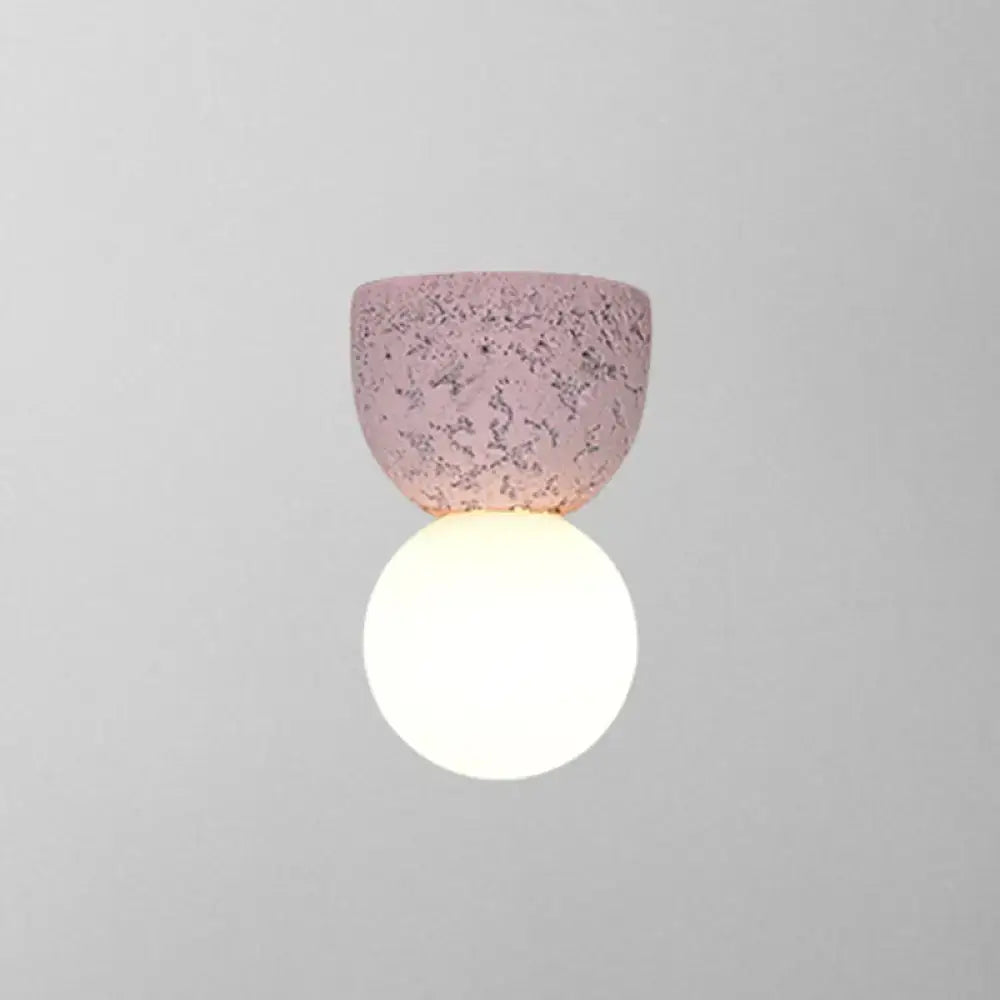 Pink concrete wall sconce by Decorbites with a textured pink shade and white globe on Tampa Home & Garden Store