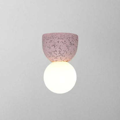 Pink concrete wall sconce by Decorbites with a textured pink shade and white globe on Tampa Home & Garden Store