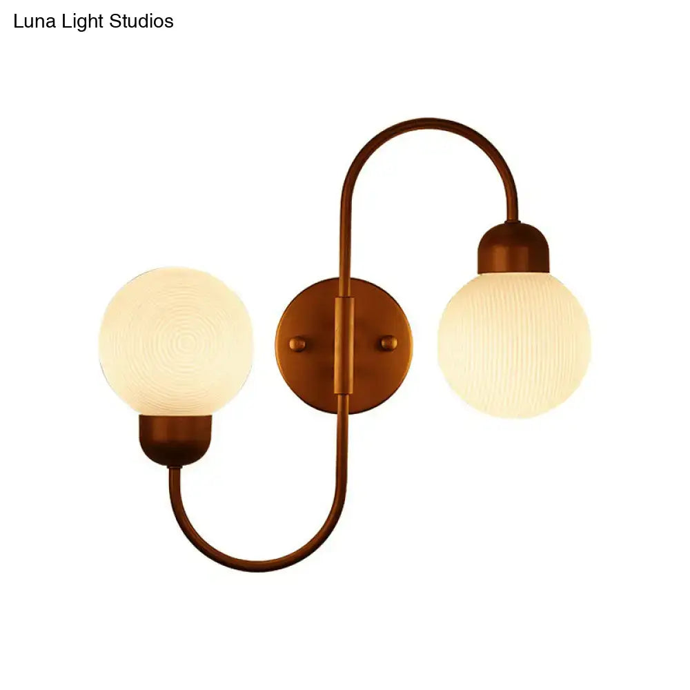Copper spherical wall sconce by Decorbites with dual frosted glass globes and curved arms on Tampa Home & Garden Store