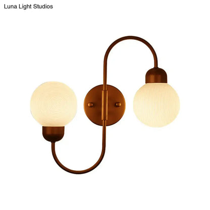 Copper spherical wall sconce by Decorbites with dual frosted glass globes and curved arms on Tampa Home & Garden Store