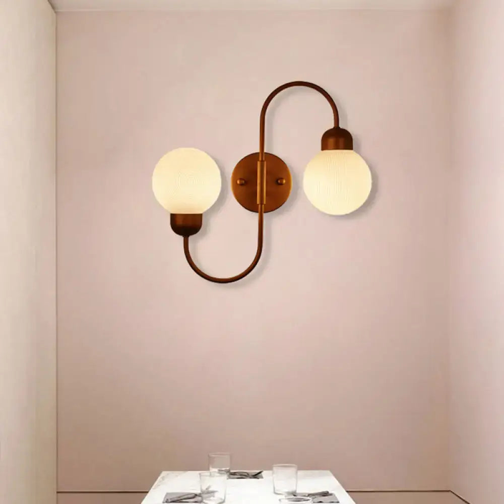 Copper spherical wall sconce by Decorbites with frosted glass globes and curved copper arm on Tampa Home & Garden Store