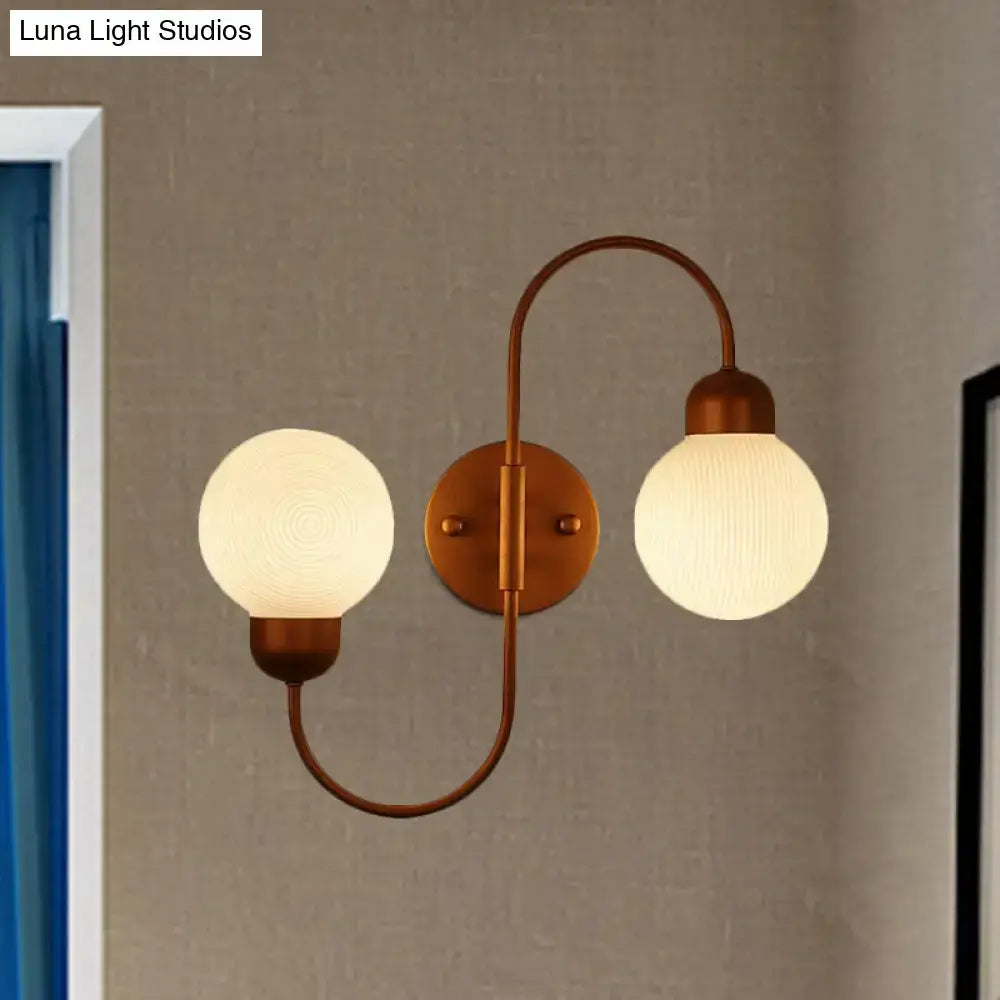 Copper spherical wall sconce with dual frosted glass globes on copper arc by Decorbites on Tampa Home & Garden Store