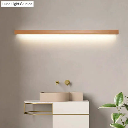 Modern copper linear LED wall sconce by Decorbites with warm glow above white vanity on Tampa Home & Garden Store