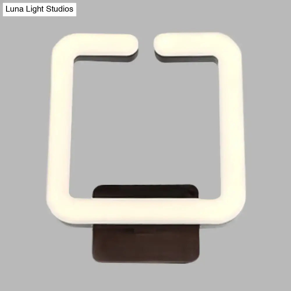 Cream square wall sconce by Decorbites with a glowing white frame and dark brown mount on Tampa Home & Garden Store