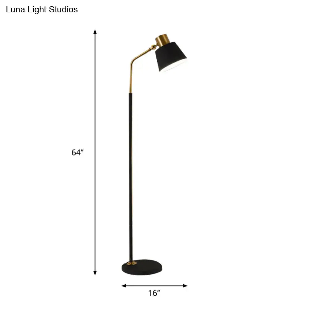 Decorbites floor lamp with black stem, gold curved arm, and black shade; 64in tall, round base on Tampa Home & Garden Store