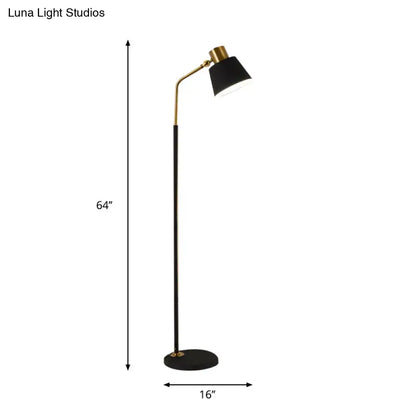 Decorbites floor lamp with black stem, gold curved arm, and black shade; 64in tall, round base on Tampa Home & Garden Store