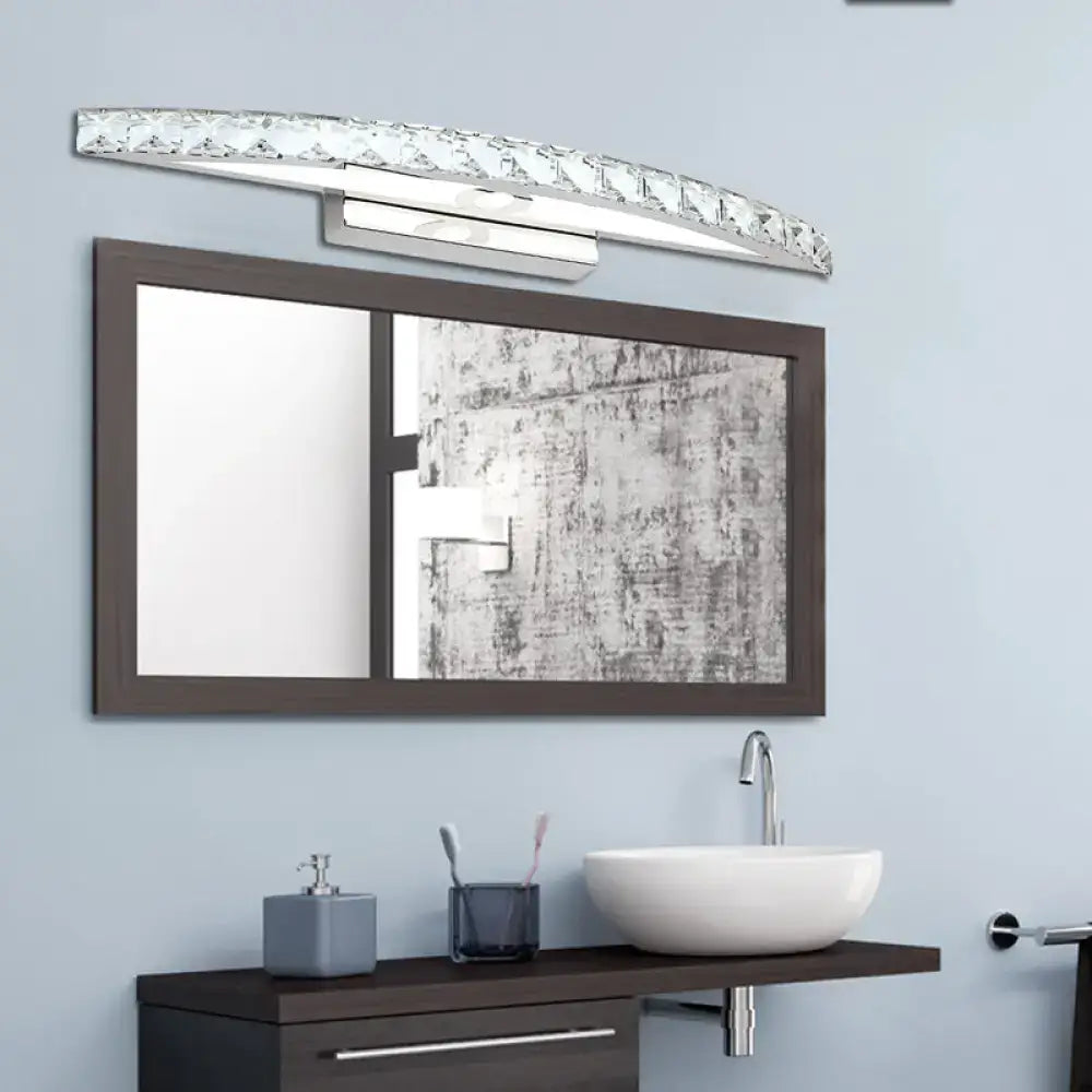 Decorbites Crystal Champagne Bow Sconce with curved crystal strip over a bathroom mirror on Tampa Home & Garden Store