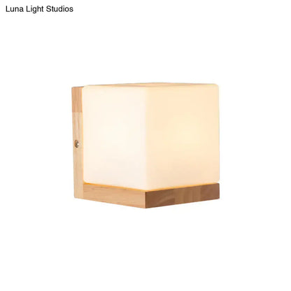 White cube wall sconce by Decorbites with frosted cube shade and wooden base on Tampa Home & Garden Store