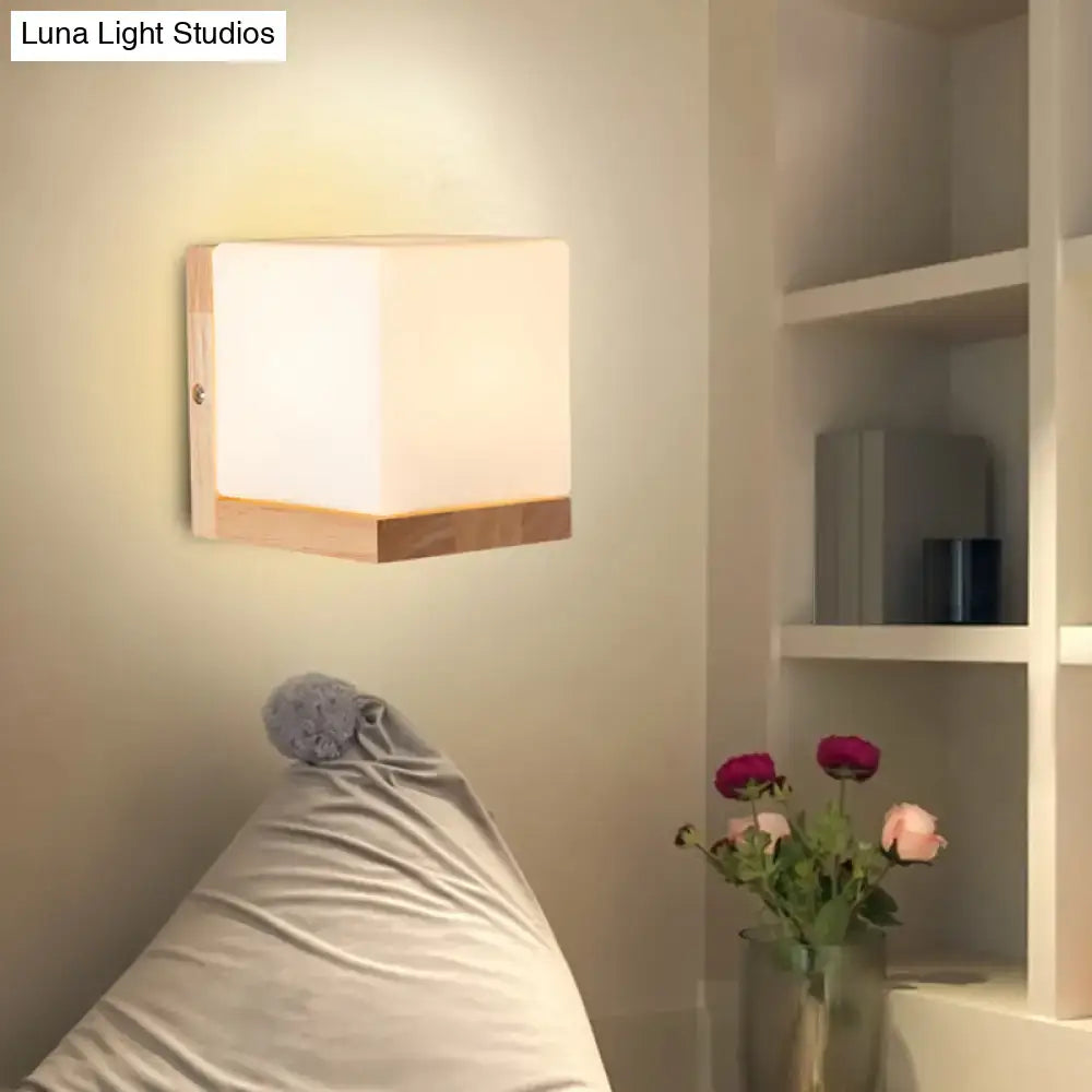 White cube wall sconce with natural wood base and warm glow, Decorbites on Tampa Home & Garden Store