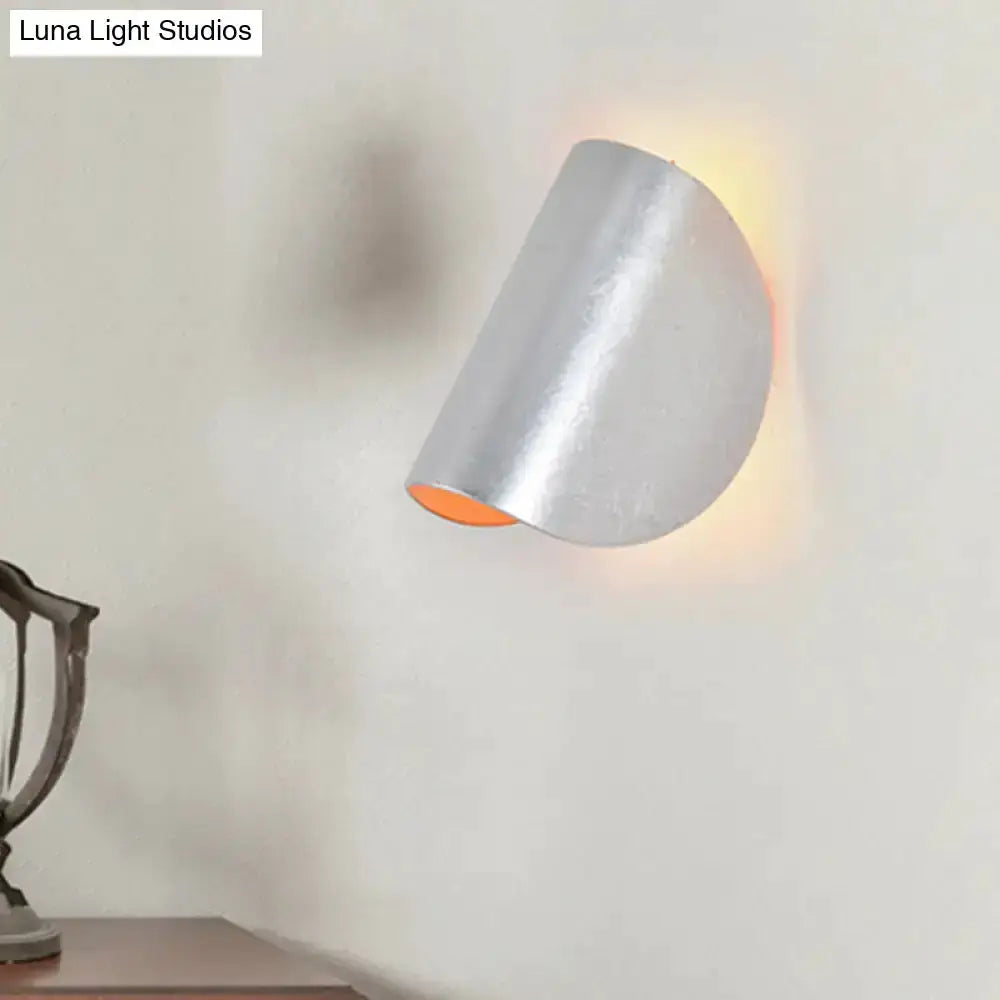 Modern curved metal wall sconce by Decorbites with silver finish and ambient lighting on Tampa Home & Garden Store