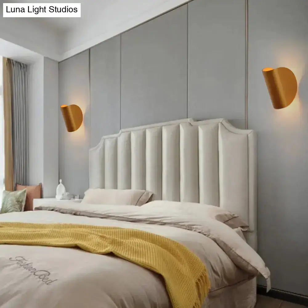 Modern curved gold wall sconces (pair) for bedroom ambient lighting on gray wall beside headboard on Tampa Home & Garden Store