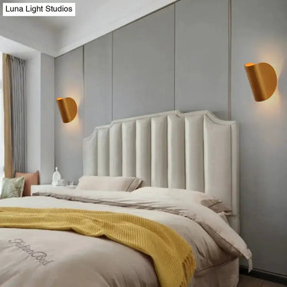 Modern curved gold wall sconces (pair) for bedroom ambient lighting on gray wall beside headboard on Tampa Home & Garden Store