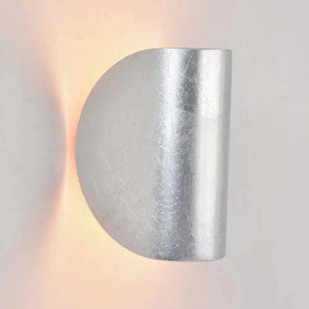 Modern curved gold wall sconce light by Decorbites with warm ambient lighting on Tampa Home & Garden Store