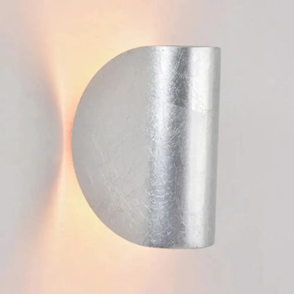 Modern curved gold wall sconce light by Decorbites with warm ambient lighting on Tampa Home & Garden Store