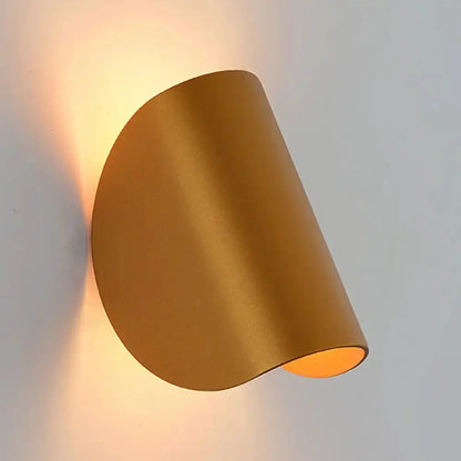 Modern curved gold wall sconce light, Decorbites, warm bedroom ambient lighting on Tampa Home & Garden Store