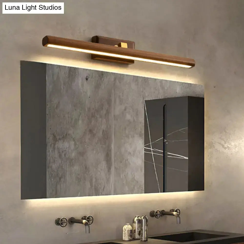 Dark Wood Linear Sconce wall-mounted LED bar with warm light above a modern bathroom mirror on Tampa Home & Garden Store