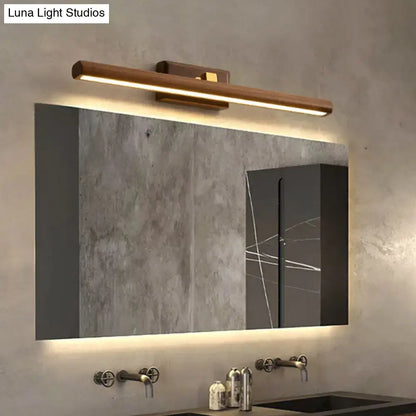 Dark Wood Linear Sconce wall-mounted LED bar with warm light above a modern bathroom mirror on Tampa Home & Garden Store