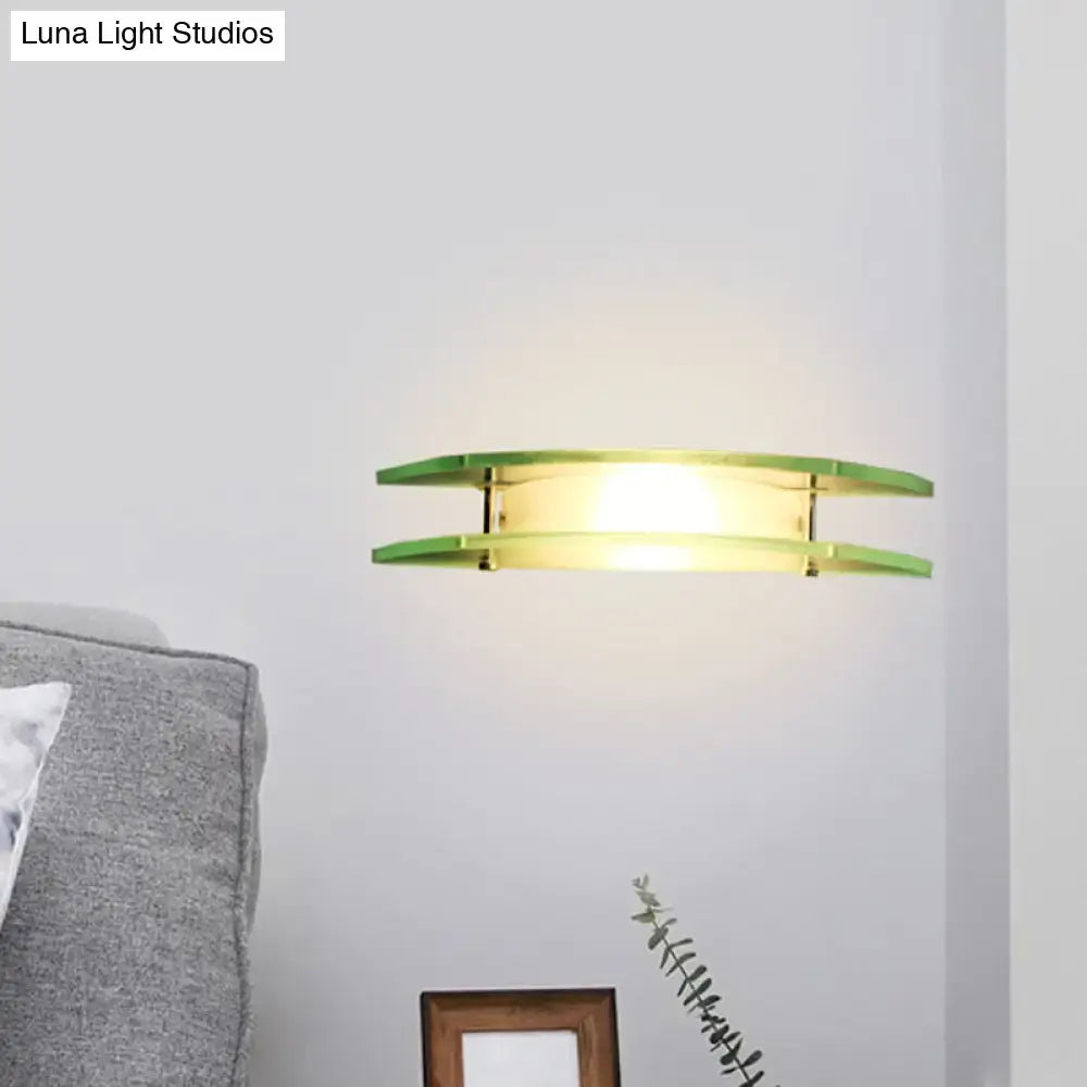 Chrome dual-arc wall sconce with green-tinted glass arcs by Decorbites warm glow on Tampa Home & Garden Store