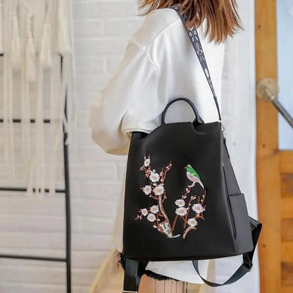 Stevvex black waterproof women's backpack with cherry blossom embroidery and a green bird on Tampa Home & Garden Store