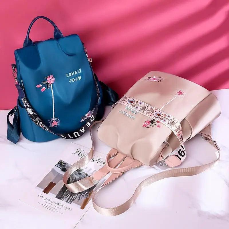 Backpacks by Stevvex: two waterproof school backpacks in blue and beige with floral prints on Tampa Home & Garden Store