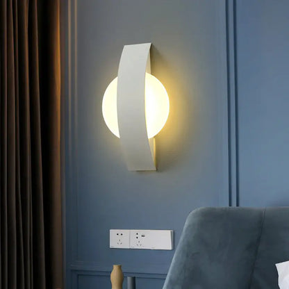 Black LED round living room wall sconce by Decorbites with ambient glow on blue wall on Tampa Home & Garden Store