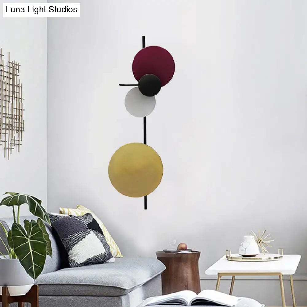Wall sconce by Decorbites with adjustable multicolor disc design on a black vertical rod on Tampa Home & Garden Store