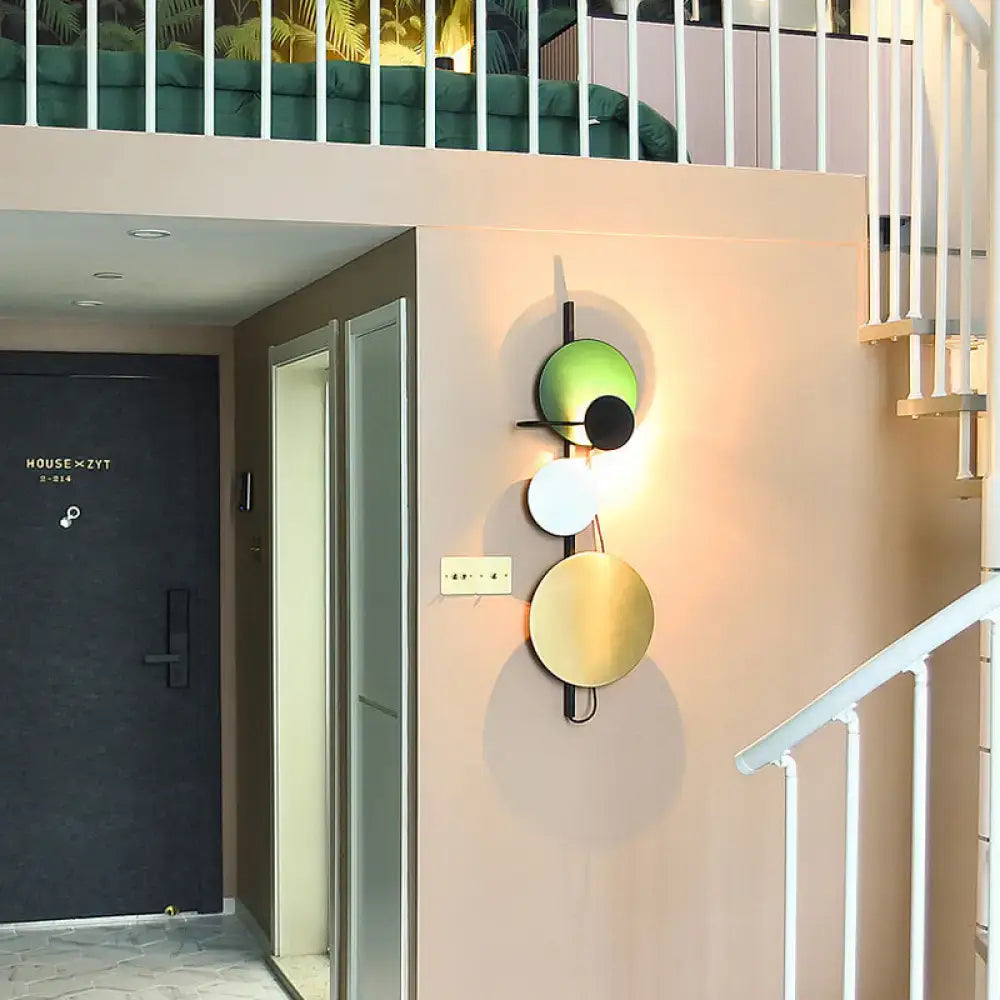 Decorbites wall sconce adjustable design with green white gold and black circular discs on Tampa Home & Garden Store