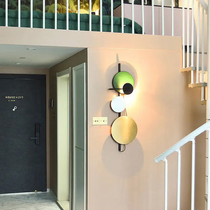 Decorbites wall sconce adjustable design with green white gold and black circular discs on Tampa Home & Garden Store