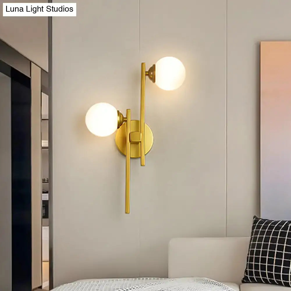 Gold Glass Dual-Light Wall Sconce with brass finish and two frosted glass globes, wall-mounted on Tampa Home & Garden Store