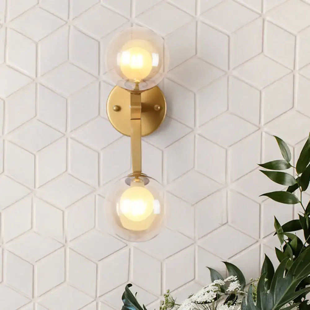 Gold amber glass wall sconce by Decorbites with dual globes on brass mount on Tampa Home & Garden Store