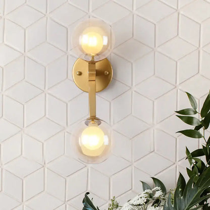 Gold amber glass wall sconce by Decorbites with dual globes on brass mount on Tampa Home & Garden Store