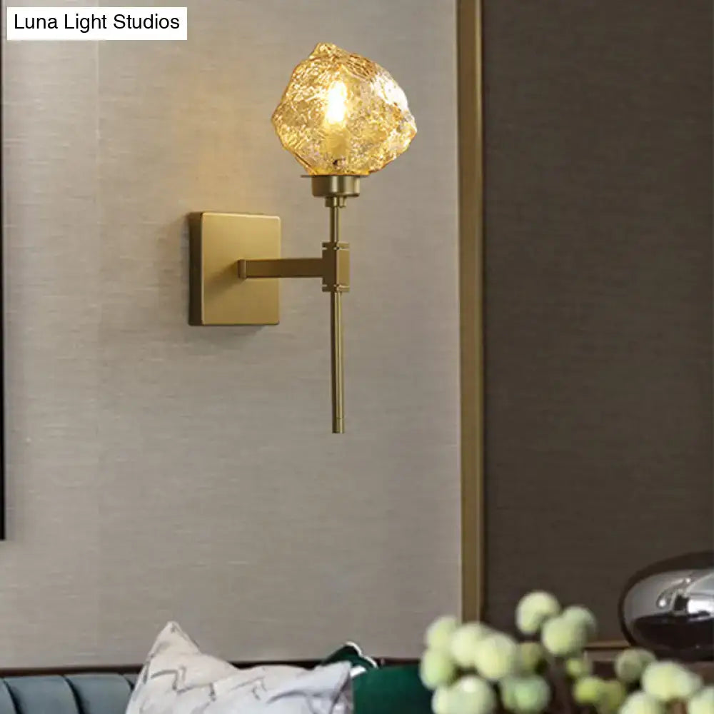Amber smoke glass wall sconce with brass square backplate and single warm light on Tampa Home & Garden Store