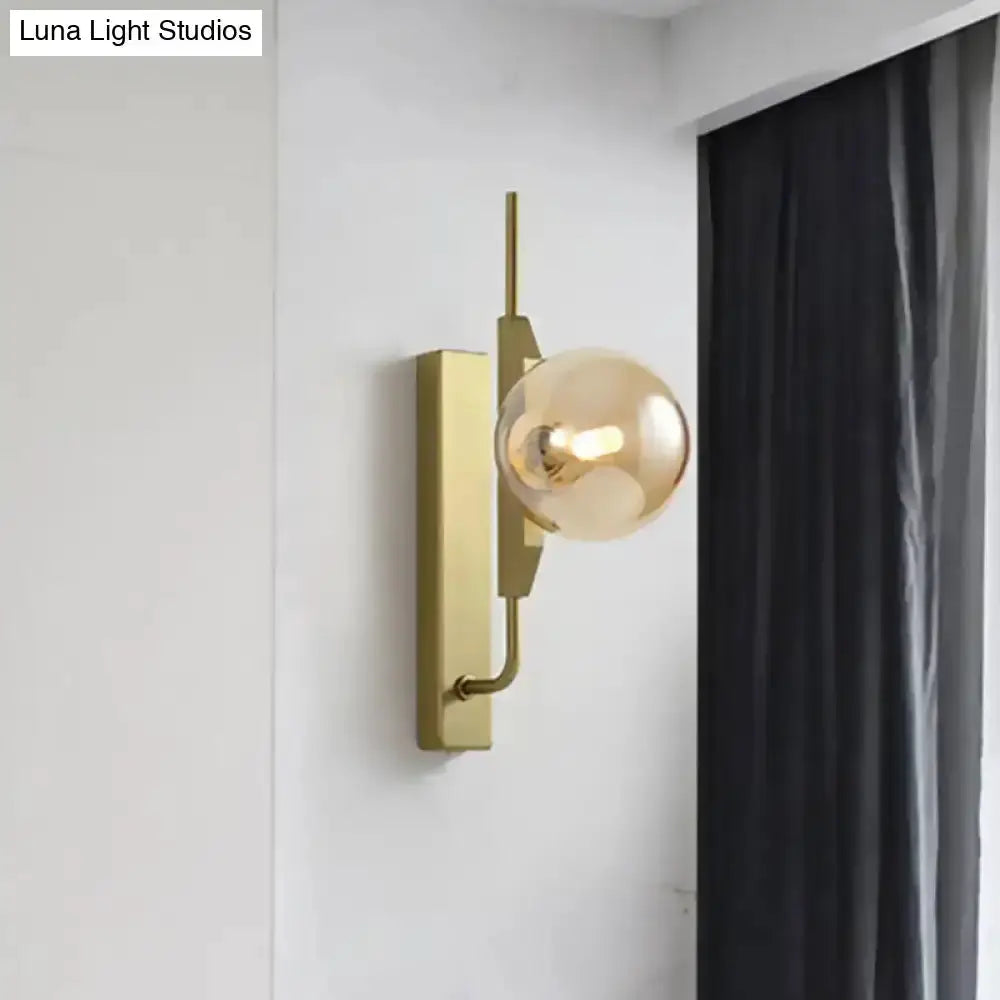Modern gold and amber glass orb wall light fixture with brass backplate for bedroom Decorbites on Tampa Home & Garden Store