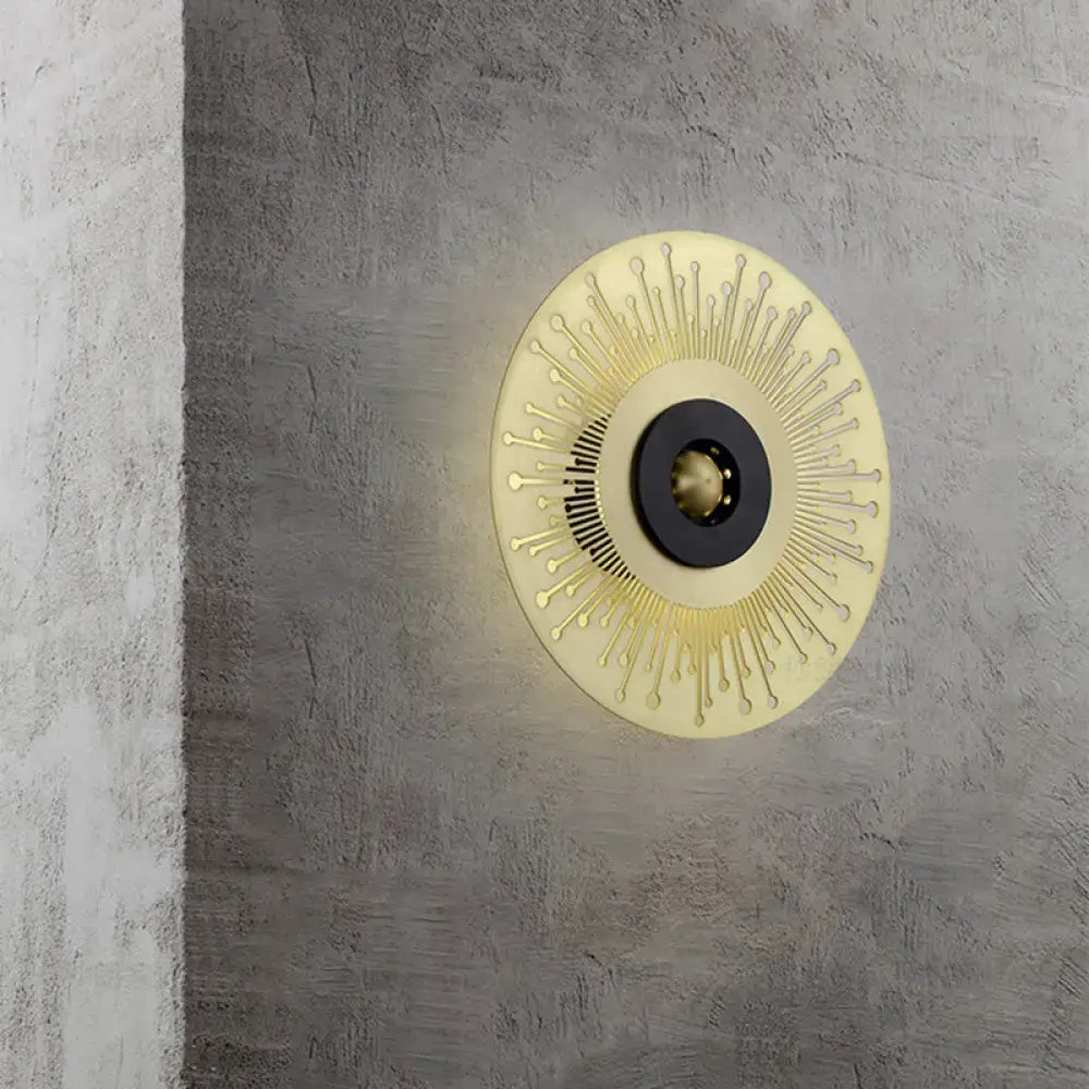 Gold Black Disk Laser-Cut Sconce with sunburst rays and black center on gray wall on Tampa Home & Garden Store