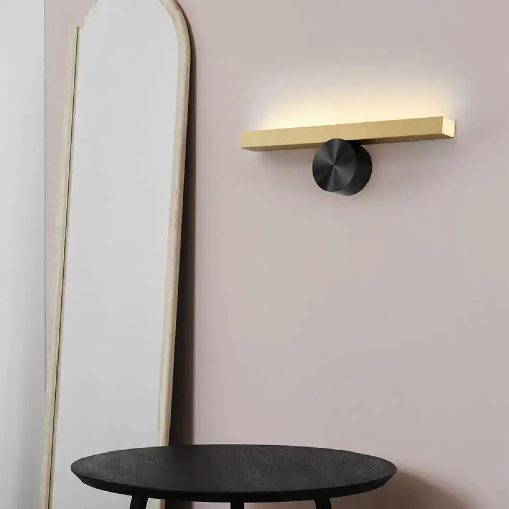 Decorbites Gold Black Linear Wall Light with warm glow and black round mounting on a gold bar on Tampa Home & Garden Store