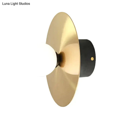 Gold Black Riya Wall Light sconce with brass disc backplate and white globe by Decorbites on Tampa Home & Garden Store