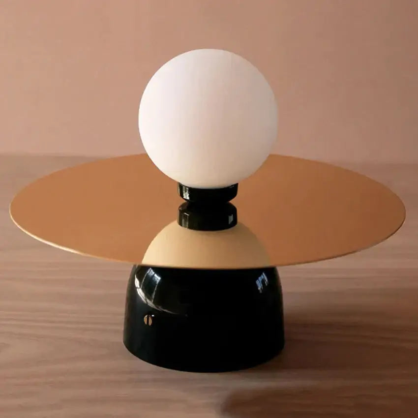 Gold Black Riya Wall Light with white globe atop black pedestal and gold circular mount on Tampa Home & Garden Store