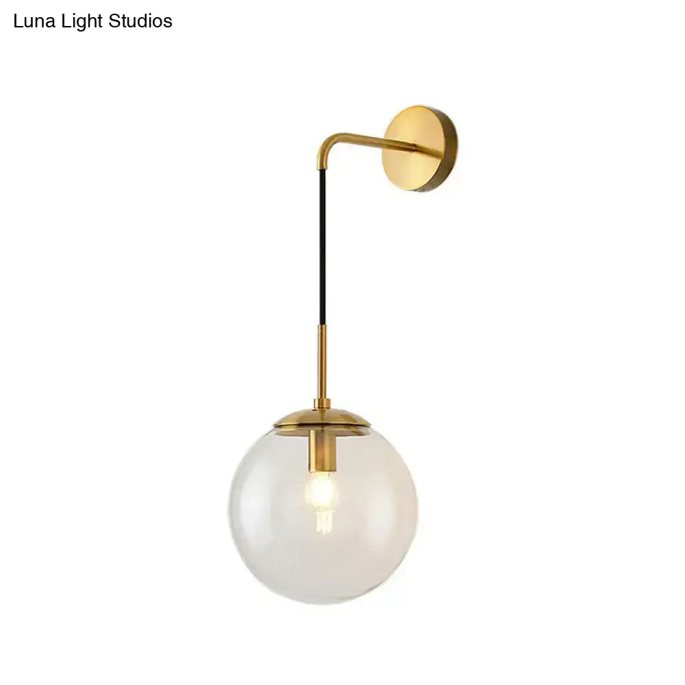 Gold Black Spherical Wall Light wall sconce with brass arm and clear glass globe by Decorbites on Tampa Home & Garden Store