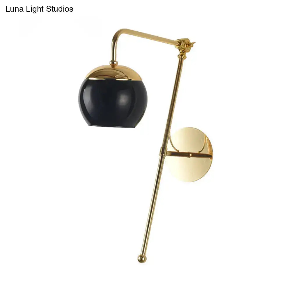 Gold brass G4 sconce with black glass globe shade, wall-mounted curved-arm design on Tampa Home & Garden Store