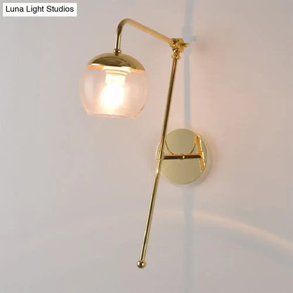 Gold Black Glass G4 Sconce with brass curved arm and clear glass shade on wall on Tampa Home & Garden Store