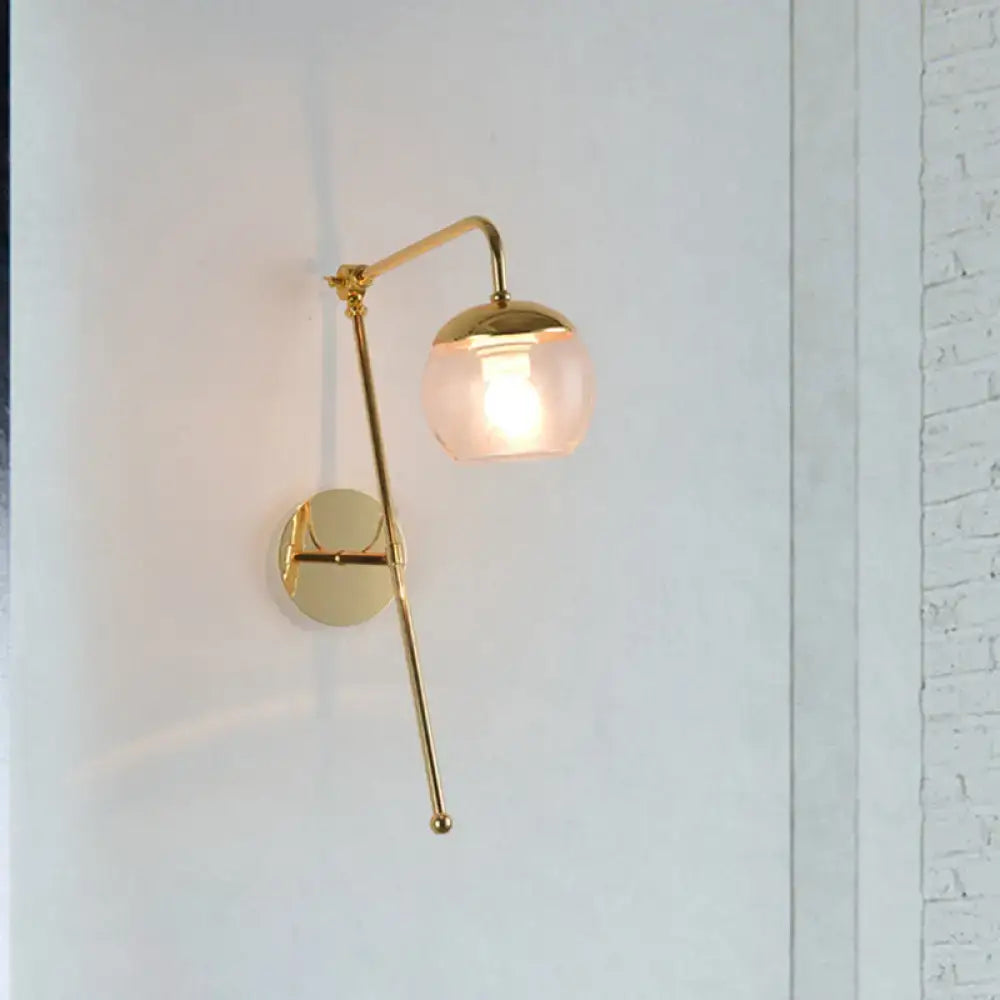 Gold brass G4 sconce with pink glass shade on curved arm, wall-mounted single-light on Tampa Home & Garden Store