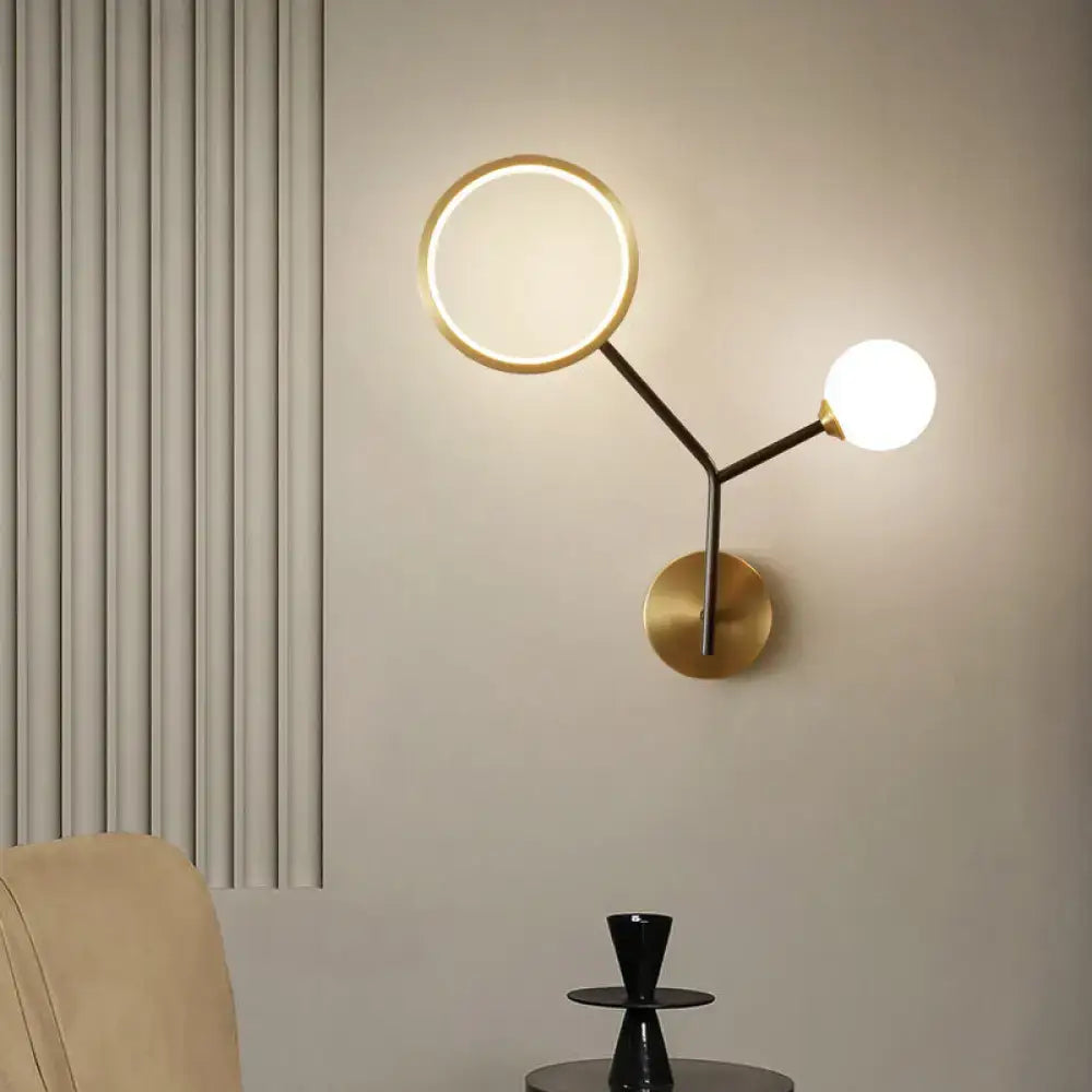 Gold cream glass compact wall sconce by Decorbites with circular ring and brass globe on Tampa Home & Garden Store